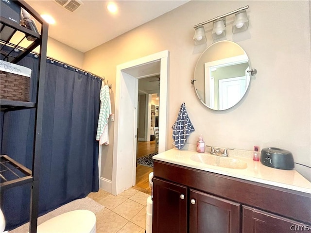 bathroom featuring vanity, toilet, a shower with shower curtain, and tile patterned flooring