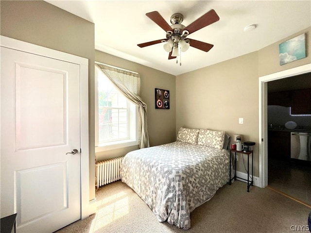 bedroom with ceiling fan, radiator, and light carpet