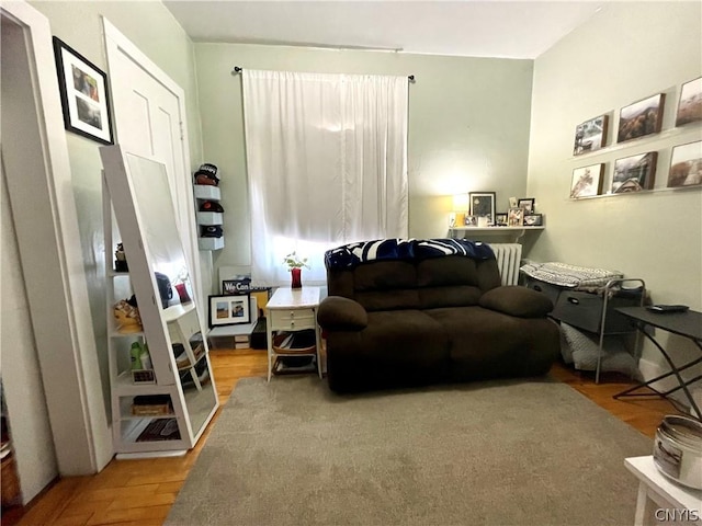 sitting room featuring hardwood / wood-style flooring and radiator