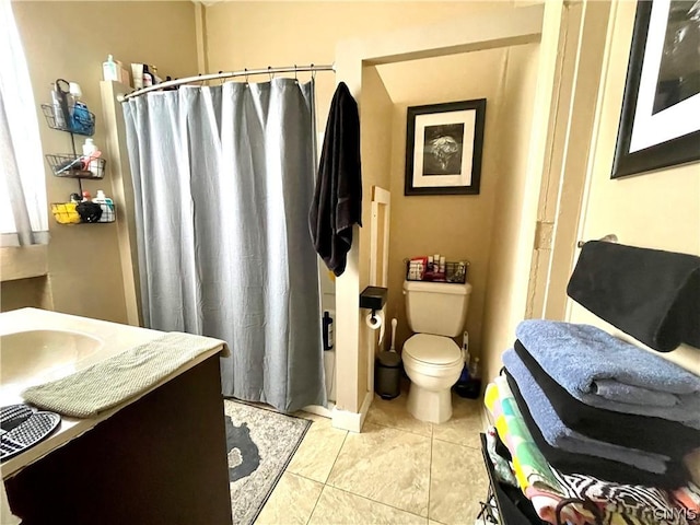 bathroom featuring toilet, vanity, and tile patterned flooring