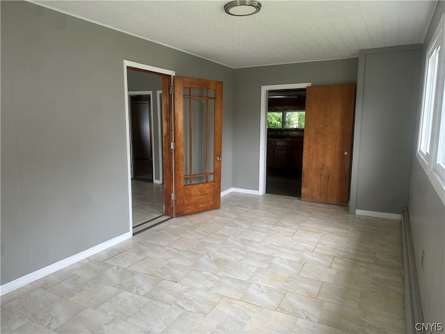 unfurnished bedroom with light tile floors