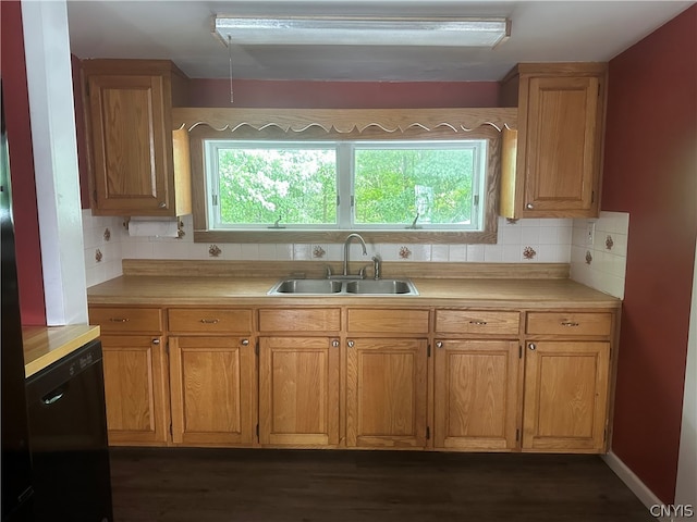 kitchen featuring plenty of natural light, sink, and backsplash