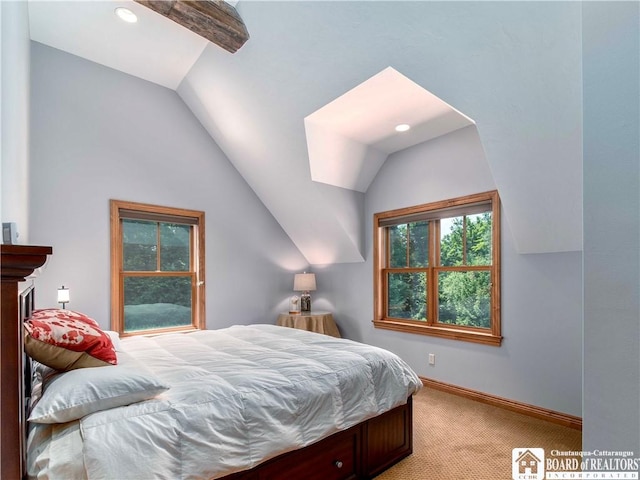 carpeted bedroom with lofted ceiling