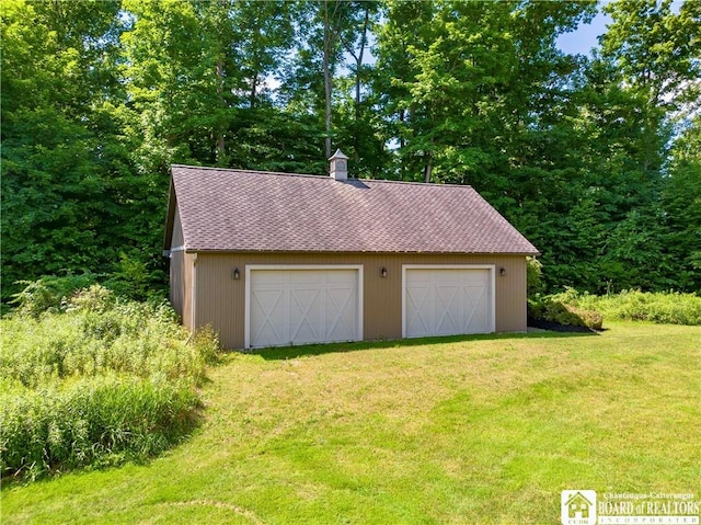 garage featuring a yard