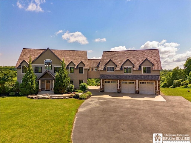 view of front of property with a garage and a front yard