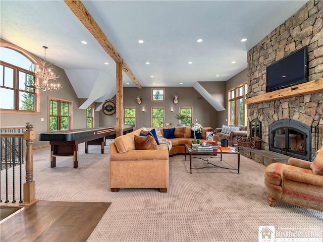 living room with carpet flooring, a high ceiling, beamed ceiling, a notable chandelier, and a fireplace