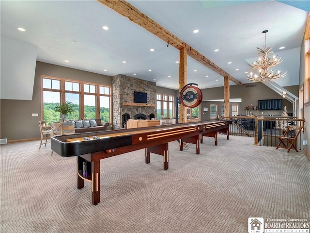 rec room with beam ceiling, light carpet, a fireplace, and an inviting chandelier