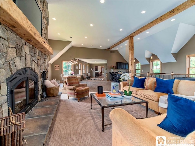 carpeted living room featuring lofted ceiling with beams and plenty of natural light