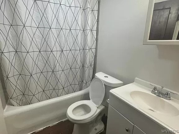 full bathroom with shower / bath combination with curtain, vanity with extensive cabinet space, and toilet