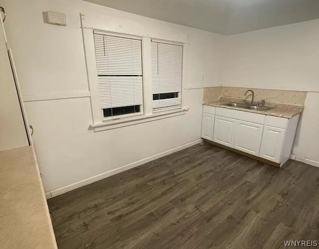 kitchen with white cabinets, dark wood-type flooring, and sink