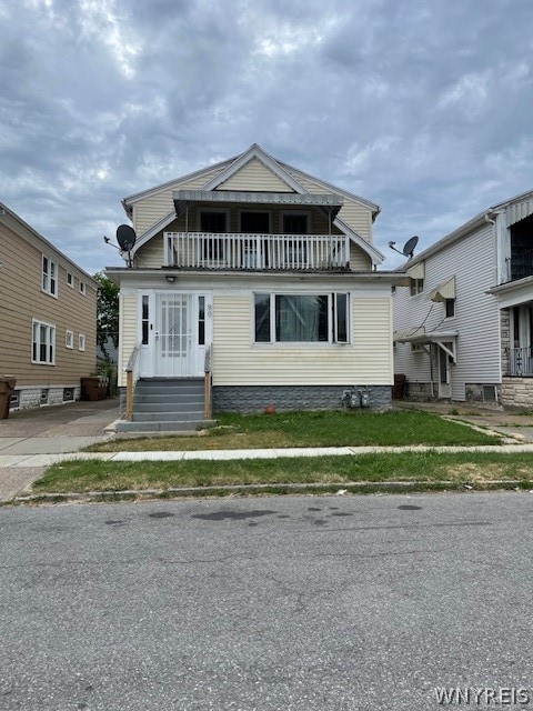 view of front of house featuring a balcony