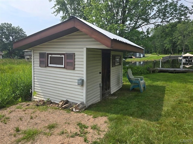 view of outbuilding featuring a yard