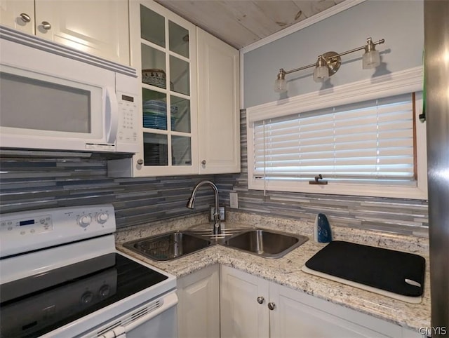 kitchen featuring tasteful backsplash, white cabinetry, and white appliances