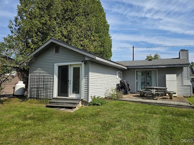 rear view of house featuring a lawn and a patio area