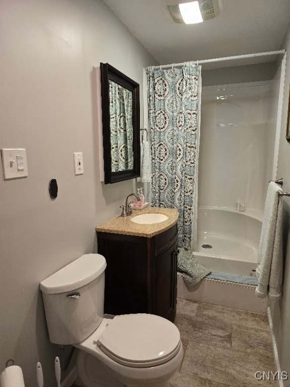 bathroom featuring a shower with curtain, toilet, and vanity