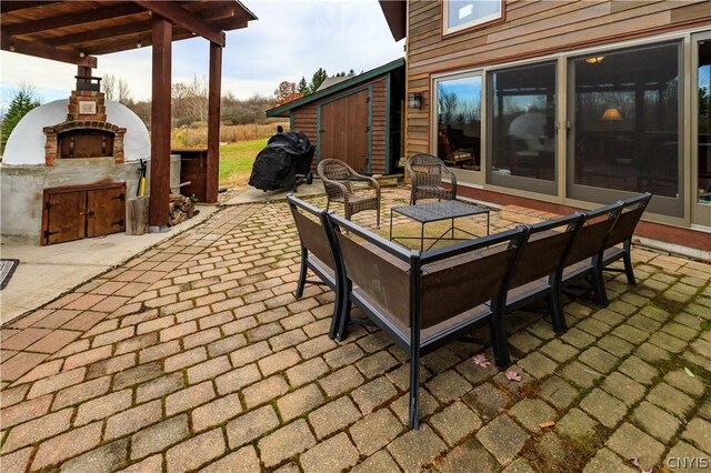 view of patio with a fireplace