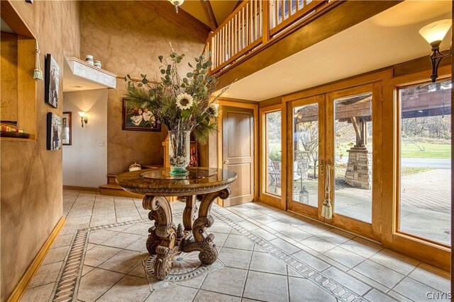 interior space with a high ceiling and french doors