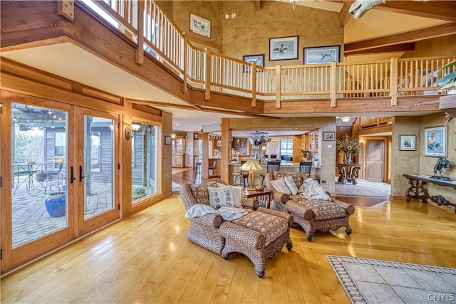 living room featuring high vaulted ceiling, french doors, and hardwood / wood-style floors