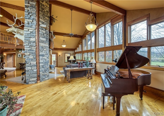 misc room featuring high vaulted ceiling, ceiling fan, and light hardwood / wood-style floors