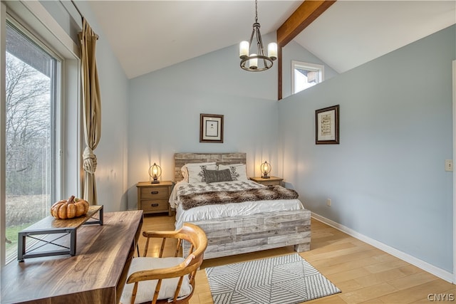 bedroom with wood-type flooring, a chandelier, beam ceiling, and multiple windows