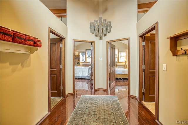 hallway with beam ceiling and hardwood / wood-style flooring