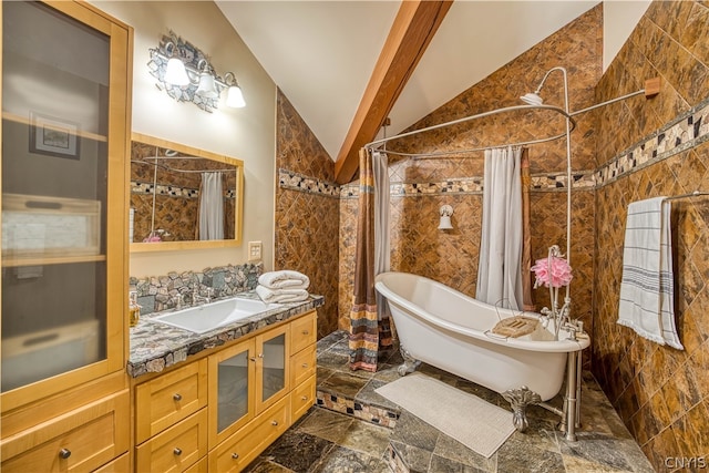 bathroom with vaulted ceiling, tile walls, a bathing tub, tile flooring, and vanity