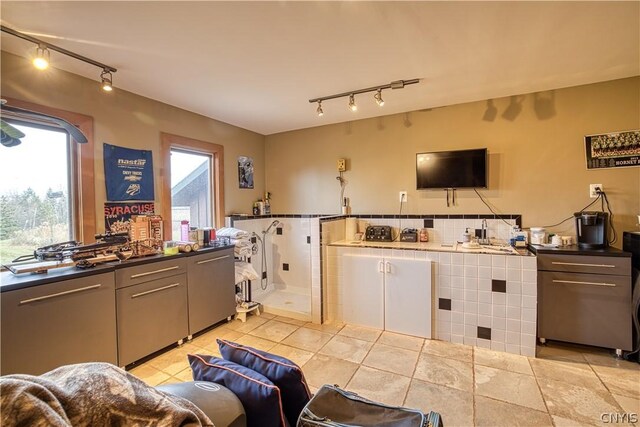 kitchen with rail lighting and light tile floors