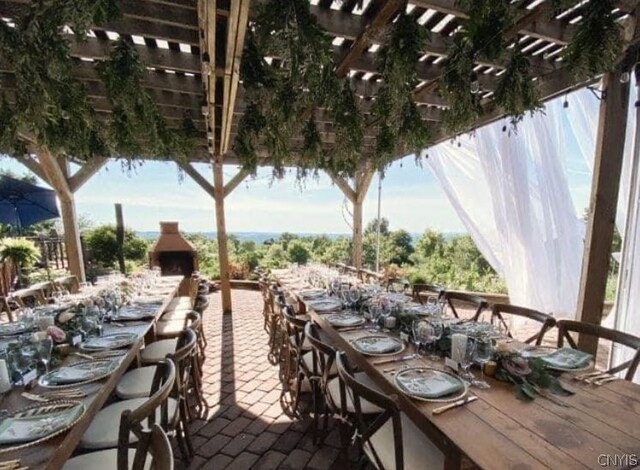 view of patio featuring a pergola and an outdoor bar