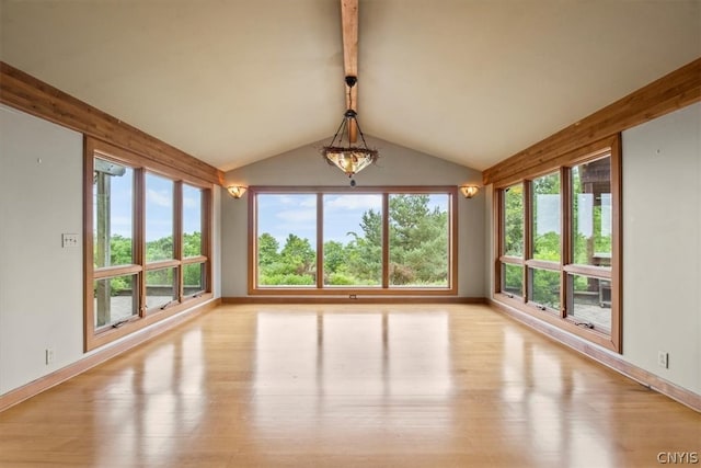 unfurnished sunroom featuring a healthy amount of sunlight and lofted ceiling with beams