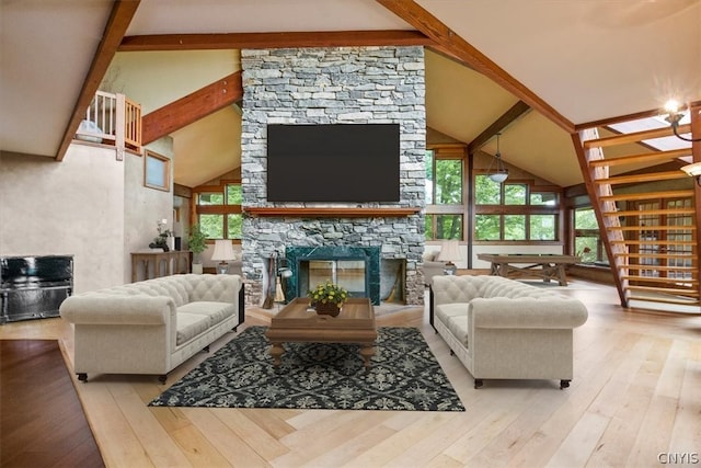 living room with high vaulted ceiling, hardwood / wood-style floors, a fireplace, and beam ceiling