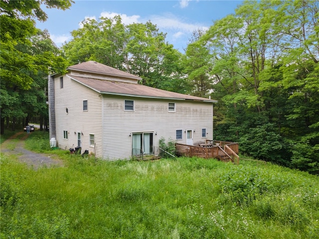 rear view of property with a wooden deck