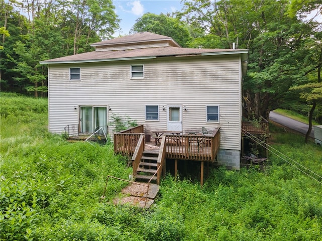 rear view of property featuring a deck