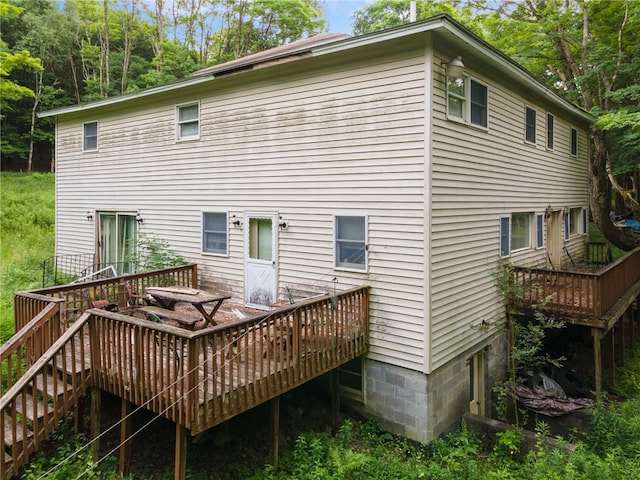 back of property featuring a deck