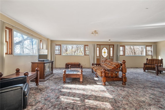 living room with plenty of natural light and dark carpet