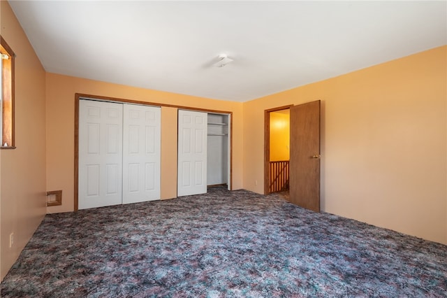 unfurnished bedroom with a closet and carpet