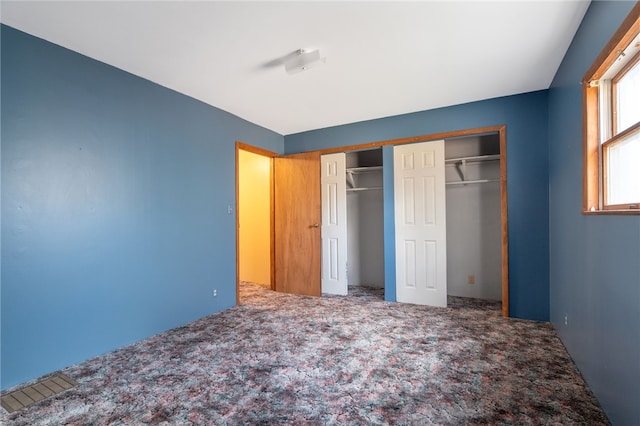 unfurnished bedroom featuring a closet and carpet