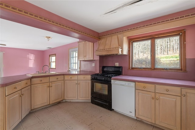 kitchen featuring black gas range oven, sink, premium range hood, white dishwasher, and kitchen peninsula