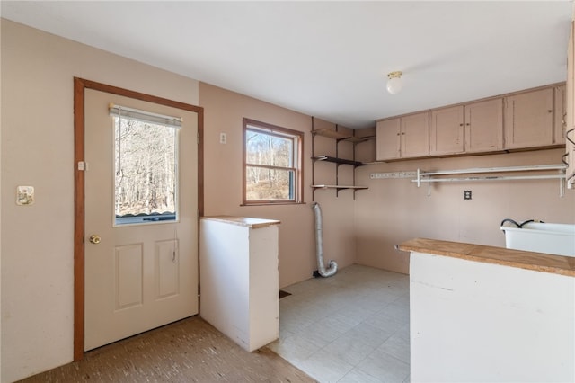 laundry room featuring cabinets