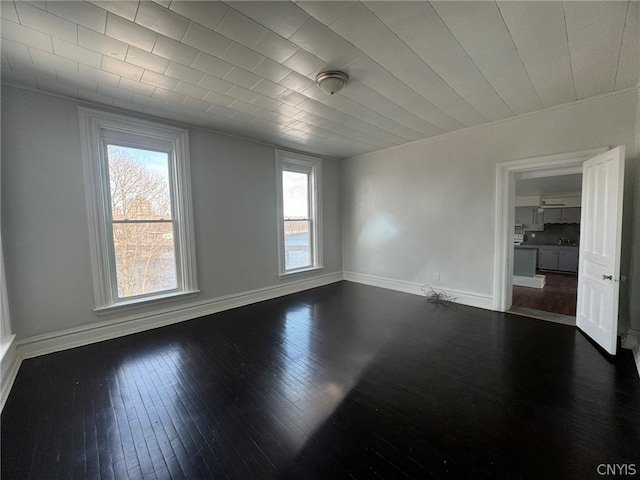 empty room featuring dark hardwood / wood-style floors and a healthy amount of sunlight