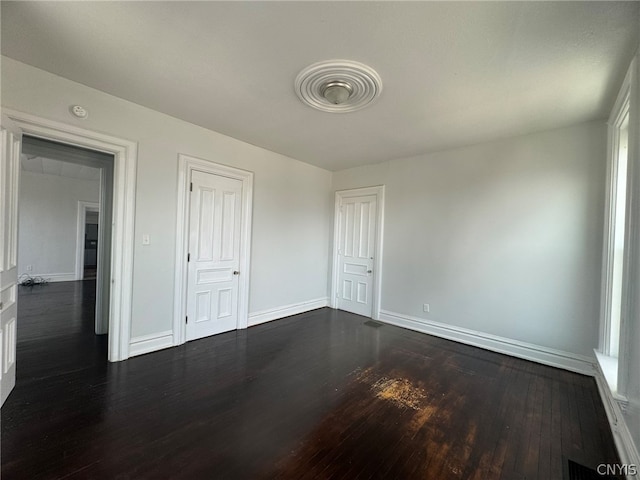 unfurnished bedroom featuring dark wood-type flooring