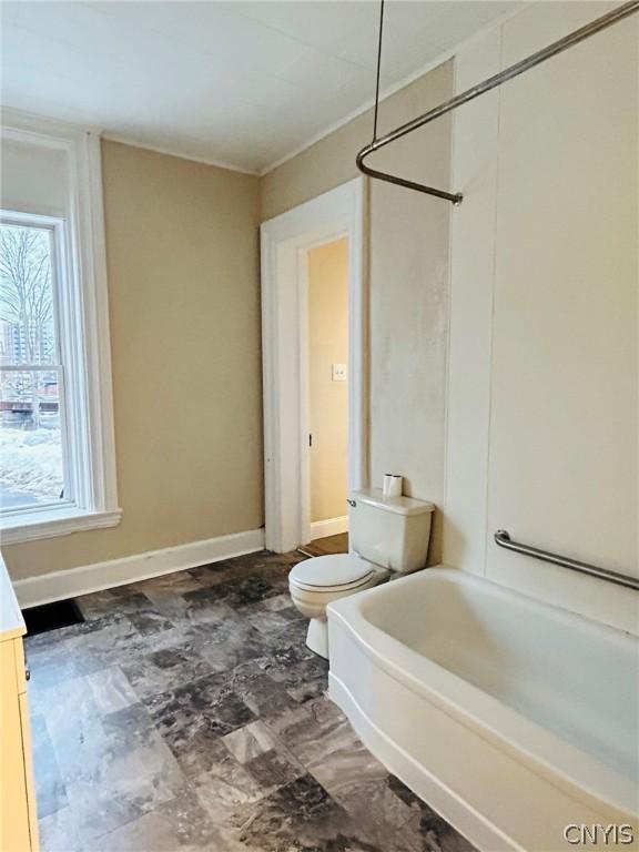 full bathroom with tile flooring, plenty of natural light, vanity, and toilet