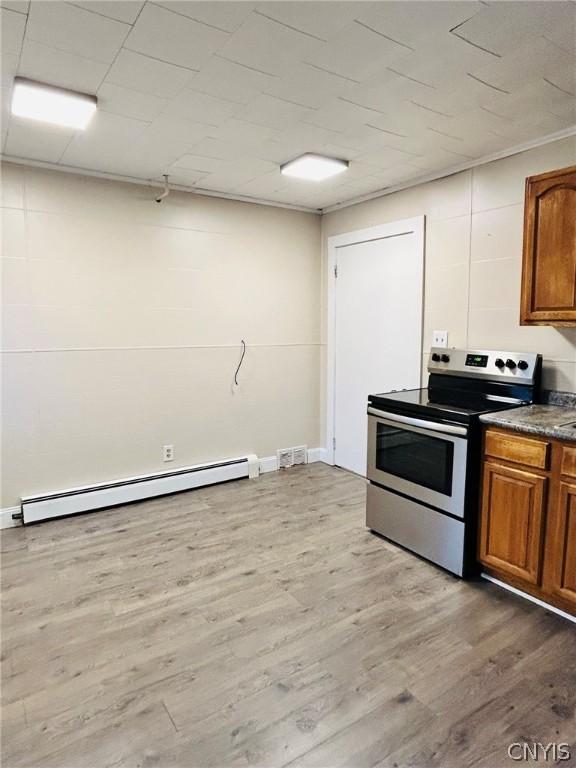 kitchen featuring a baseboard heating unit, electric range, and hardwood / wood-style floors