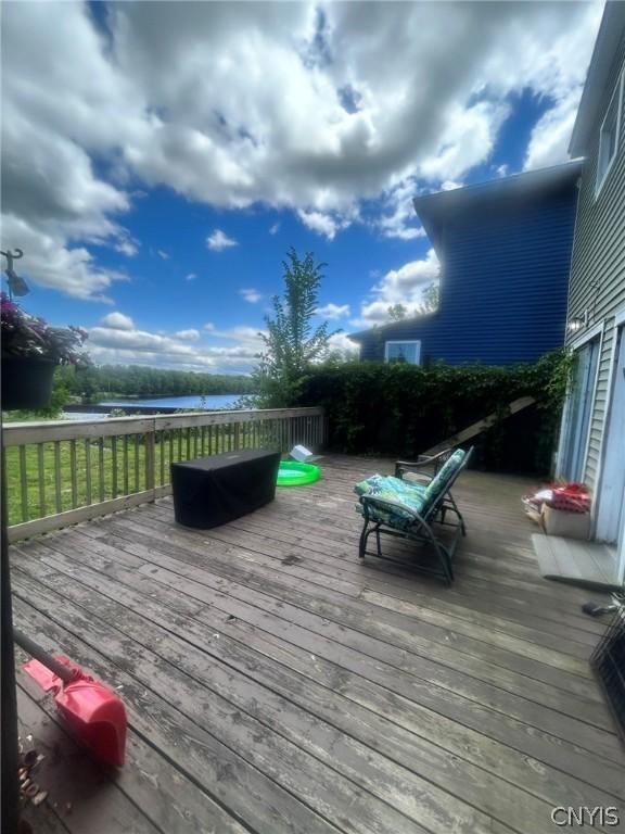 wooden terrace featuring a water view