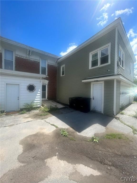 view of side of home featuring a garage