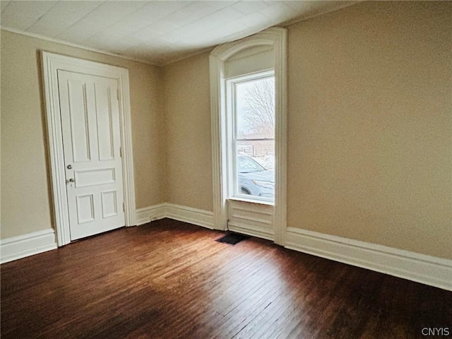 unfurnished room featuring dark wood-style floors and baseboards