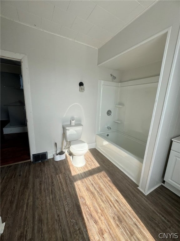 full bathroom with shower / bathtub combination, wood-type flooring, vanity, and toilet