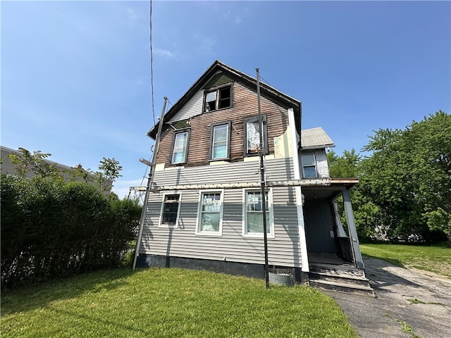 back of property featuring a lawn