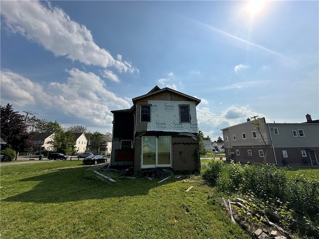 rear view of property with a yard