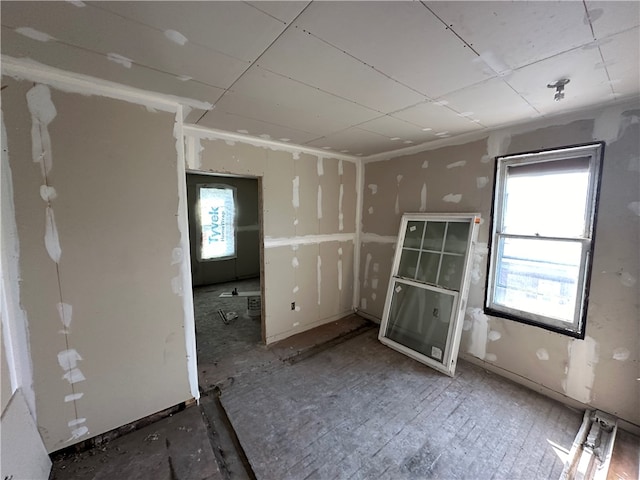 interior space featuring a healthy amount of sunlight and a drop ceiling