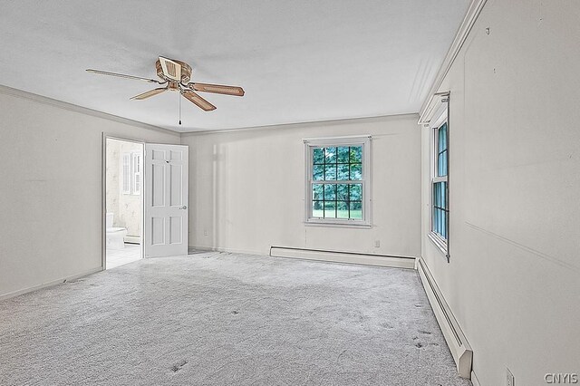 carpeted spare room featuring baseboard heating, ceiling fan, and ornamental molding